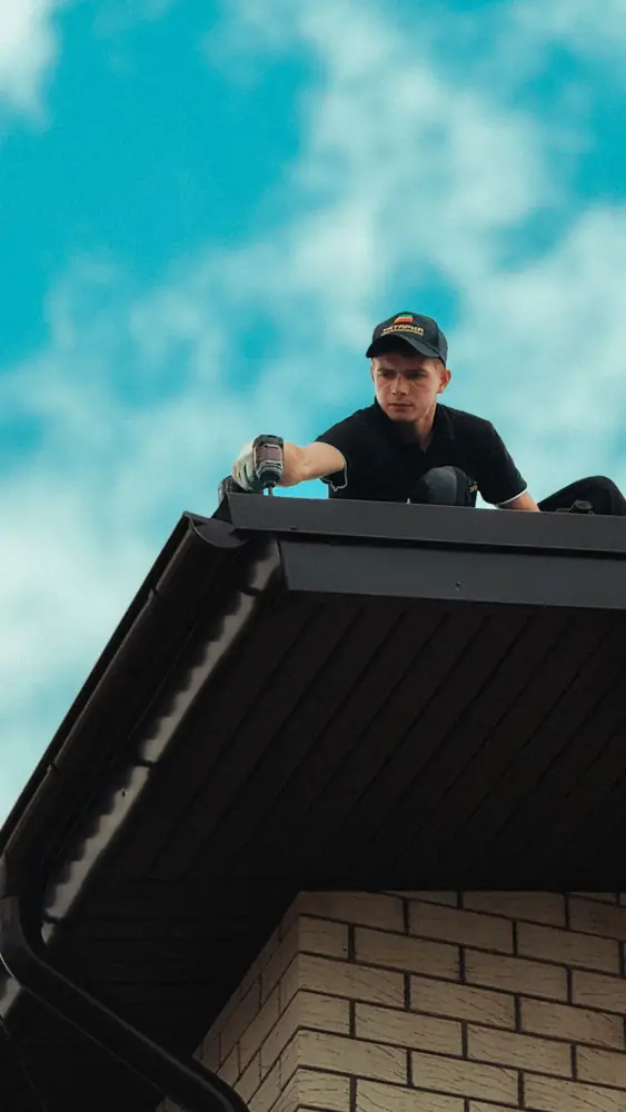 Licensed roofer working on a house roof