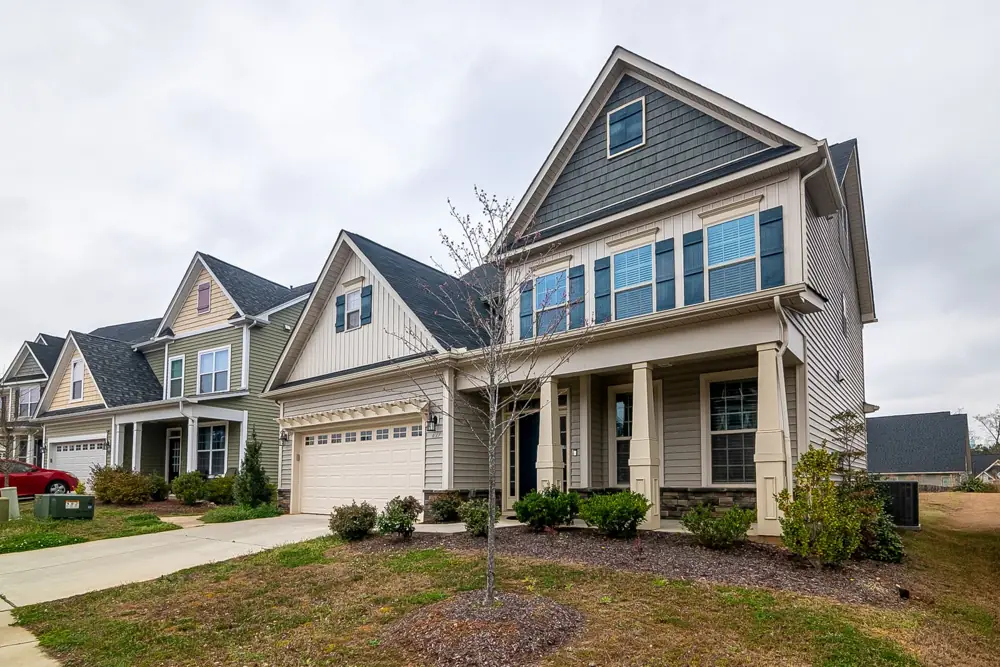 Two-story single-family homes with lawns and driveways